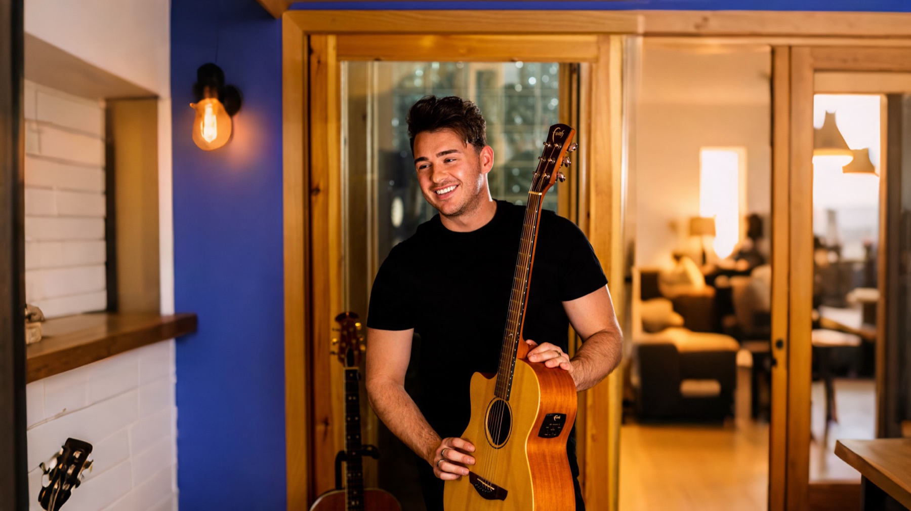 Scott Wilkes with an acoustic guitar